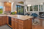 The custom wood kitchen is modern and fully-equipped